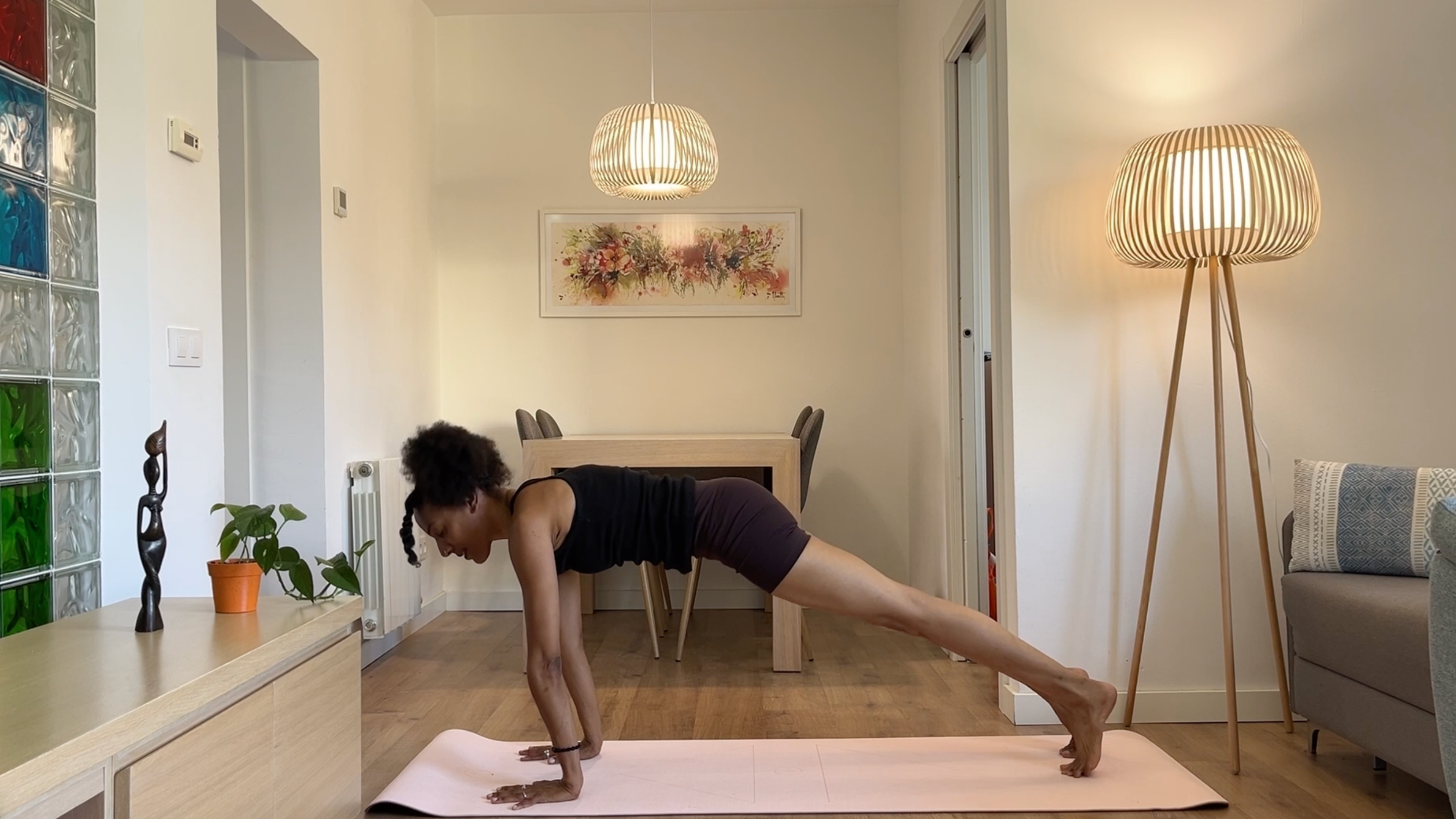 A person in Plank pose, balancing on their hands and toes with arms straight, keeping their body in a strong, straight line from head to heels.